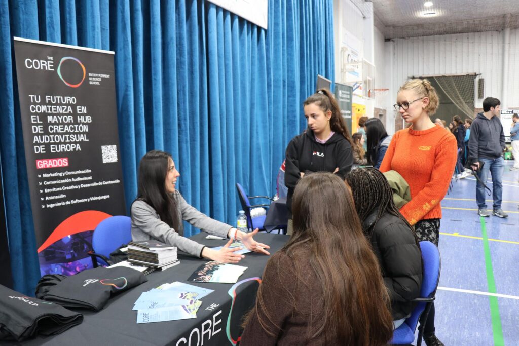 Alumnas escuchando la explicación de la oferta de una universidad