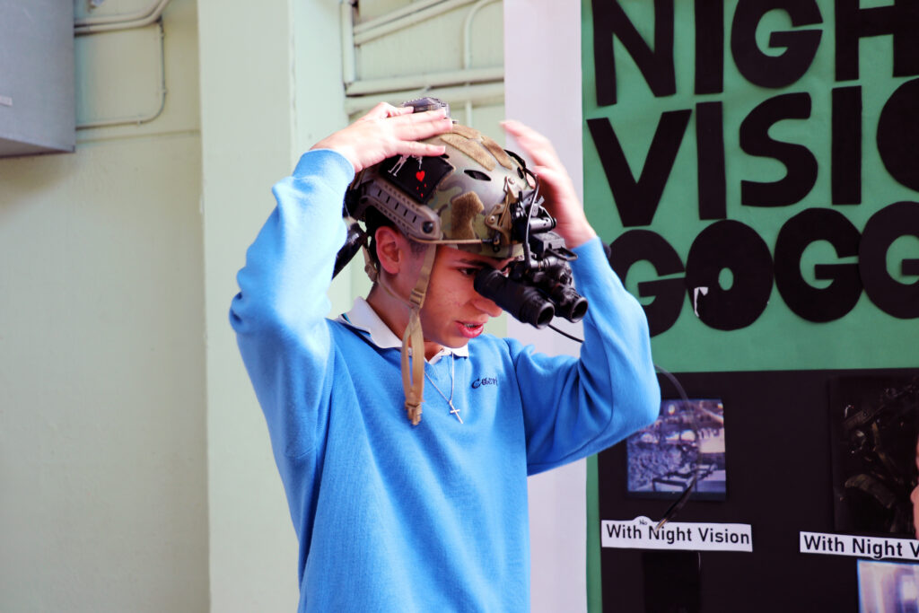 A student trying on his night-vision goggles as part of his MYP project
