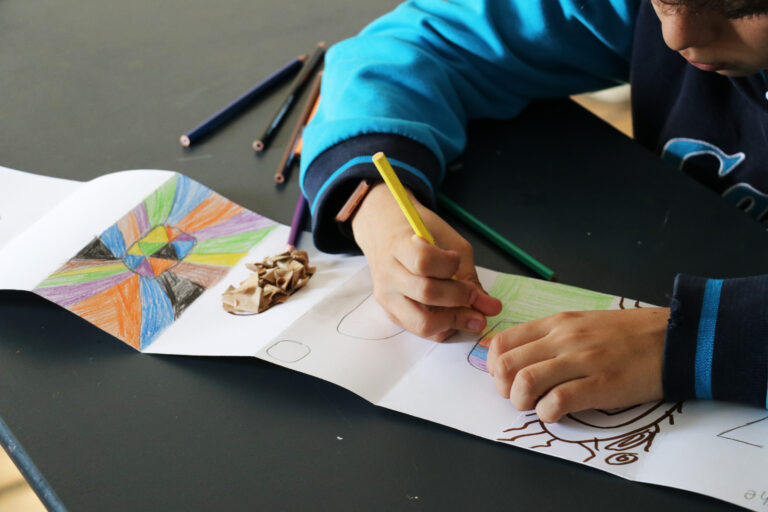 A person painting and exploring their creativity on a piece of paper